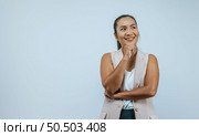 Portrait of smiling Asian woman 30s in casual clothes looking aside put hand prop up on chin isolated on wall background in studio. Mock up copy space. Стоковое фото, агентство Ingram Publishing / Фотобанк Лори
