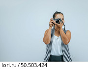 Portrait of Asian woman wearing casual clothes with a big smile on face,  taking pictures with camera. Isolated background in studio with blank space. Стоковое фото, агентство Ingram Publishing / Фотобанк Лори