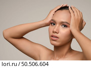Portrait with manicure hands of beautiful asian woman touch on head, beautiful natural clean skin nature make up,  fresh spa female beauty cometic, shampoo cleansing, copy space. Стоковое фото, агентство Ingram Publishing / Фотобанк Лори
