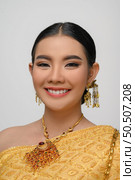 Headshot, portrait Beautiful Asian woman in traditional Thai dress costume smile and pose gracefully on white background. Стоковое фото, агентство Ingram Publishing / Фотобанк Лори