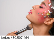 woman wearing pink makeup and holding a blush brush. Isolated on white background. Стоковое фото, агентство Ingram Publishing / Фотобанк Лори