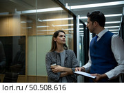Two young business in the corridor of the conference room Rehearse information to present results and new projects to the management team for consideration. Стоковое фото, агентство Ingram Publishing / Фотобанк Лори