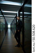 Businessman in the corridor in the conference room Relax with various posture before presenting work and new projects to the management team for consideration in the meeting room. Стоковое фото, агентство Ingram Publishing / Фотобанк Лори