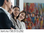 Young asian woman freshman joined the group of young entrepreneurs with three seniors on the team. Welcomed and introduced to senior management. Стоковое фото, агентство Ingram Publishing / Фотобанк Лори