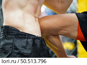 Mixed Martial Art, The power of a knee into the opponent’s abdomen causing the opponent to have colic, tightness in the stomach and lose by knockout. Стоковое фото, агентство Ingram Publishing / Фотобанк Лори