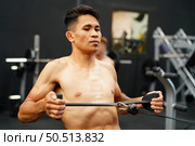 Mixed martial arts fighter going to the gym to build strong muscles To help make the collision more intense and help reduce injuries from punching as well. Стоковое фото, агентство Ingram Publishing / Фотобанк Лори