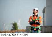 Engineer at Natural Energy Wind Turbine site with a mission to climb up to the wind turbine blades to inspect the operation of large wind turbines that converts wind energy into electrical energy. Стоковое фото, агентство Ingram Publishing / Фотобанк Лори