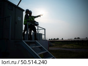 A team of electrical engineers inspecting solar panels in a hundred acre field, in the evening after completing the daily work tasks with the setting sun. Стоковое фото, агентство Ingram Publishing / Фотобанк Лори
