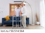 Old couple with his wife, who had to learn to walk after being treated for an osteoarthritis. Must help and take care of each other without children to take care of. Стоковое фото, агентство Ingram Publishing / Фотобанк Лори