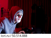 This is the face of a hacker who is knowledgeable with operating systems and other programs. He will exploit flaws and breach the computer system to cause damage. Стоковое фото, агентство Ingram Publishing / Фотобанк Лори