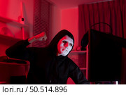 This is the face of a hacker who is knowledgeable with operating systems and other programs. He will exploit flaws and breach the computer system to cause damage. Стоковое фото, агентство Ingram Publishing / Фотобанк Лори