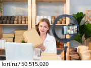 Young female runs a small business making clay jewelry. Presented to customers with products via an internet channel. Стоковое фото, агентство Ingram Publishing / Фотобанк Лори