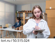 A young couple runs a small business making clay jewelry. They support one another as they work toward becoming larger business in the future. Стоковое фото, агентство Ingram Publishing / Фотобанк Лори