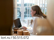 Young female runs a small business making clay jewelry. Presented to customers with products via an internet channel. Стоковое фото, агентство Ingram Publishing / Фотобанк Лори