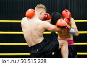 Muay Thai, The martial art of Thailand, The power of a knee into the opponent’s abdomen causing the opponent to have colic, tightness in the stomach and lose by knockout. Стоковое фото, агентство Ingram Publishing / Фотобанк Лори