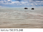 Boats Floating on the Surface of Tonle Sap Lake in Cambodia. Стоковое фото, фотограф Aleksandr Golubev / Фотобанк Лори