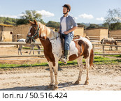 Young man riding horse in paddock. Стоковое фото, фотограф Яков Филимонов / Фотобанк Лори