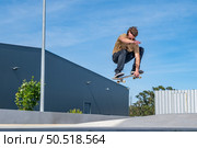 Skateboarder doing ollie trick on a urban scene. Стоковое фото, агентство Ingram Publishing / Фотобанк Лори