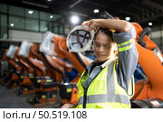 Portrait of female engineer with the mission of auditing, testing, improving software and calibrating robotics arm. Стоковое фото, агентство Ingram Publishing / Фотобанк Лори