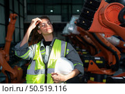 Portrait of female engineer with the mission of auditing, testing, improving software and calibrating robotics arm. Стоковое фото, агентство Ingram Publishing / Фотобанк Лори