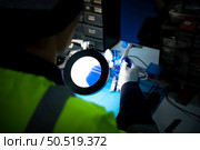 The technician must use bright lights and a magnifying glass to check the detail of the workpiece. the 3D printer’s printout. Стоковое фото, агентство Ingram Publishing / Фотобанк Лори