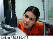 In an electronic parts facility, Female engineers In the plant, inspecting and testing robotic hands used in the production of electronic components. Стоковое фото, агентство Ingram Publishing / Фотобанк Лори
