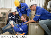 Working in a large industrial facility with heavy materials and machinery. Safety considerations are therefore of the utmost significance. Extreme vigilance must be exercised in this situation. Стоковое фото, агентство Ingram Publishing / Фотобанк Лори