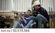 Working in a large industrial facility with heavy materials and machinery. Safety considerations are therefore of the utmost significance. Extreme vigilance must be exercised in this situation. Стоковое фото, агентство Ingram Publishing / Фотобанк Лори