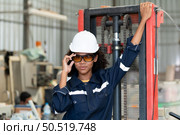Portrait of a young female engineer in the welding robot industry, posed like a top model. Стоковое фото, агентство Ingram Publishing / Фотобанк Лори