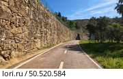 Point of view shot of riding a bicycle in Sever do Vouga, Portugal. Features a wide view of the bike track and the natural scenery. Стоковое фото, агентство Ingram Publishing / Фотобанк Лори