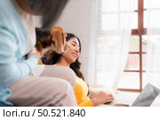 Family vacation, mother, daughter, and beagle puppy relaxing on weekends in the house’s leisure room. Стоковое фото, агентство Ingram Publishing / Фотобанк Лори