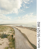 View from the walkway south of Furadouro beach in Ovar on a cloudy day. Стоковое фото, агентство Ingram Publishing / Фотобанк Лори