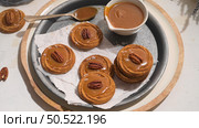 Caramel cookies with pecan nuts served on roud plates, in the kitchen after baking. Стоковое фото, агентство Ingram Publishing / Фотобанк Лори