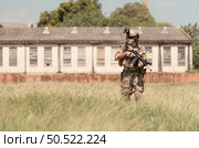 Special forces soldier in camouflage with a pair of weapons that are full of modern technology and complete for battle. Стоковое фото, агентство Ingram Publishing / Фотобанк Лори