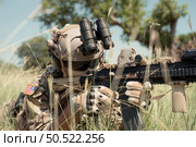 Special forces soldier in camouflage with a pair of weapons that are full of modern technology and complete for battle. Стоковое фото, агентство Ingram Publishing / Фотобанк Лори