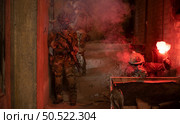 Soldier in anti-terrorist warfare in a dark building, Anti-terrorist operation training on the battlefield. Стоковое фото, агентство Ingram Publishing / Фотобанк Лори