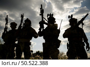 Soldier holding gun and showing action success or war win, special forces military training concept. Стоковое фото, агентство Ingram Publishing / Фотобанк Лори