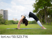 Young female with outdoor activities in the city park, Yoga is her chosen activity. Стоковое фото, агентство Ingram Publishing / Фотобанк Лори