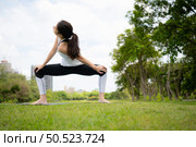 Young female with outdoor activities in the city park, Yoga is her chosen activity. Стоковое фото, агентство Ingram Publishing / Фотобанк Лори