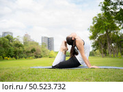 Young female with outdoor activities in the city park, Yoga is her chosen activity. Стоковое фото, агентство Ingram Publishing / Фотобанк Лори