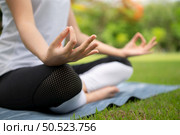 Young female with outdoor activities in the city park, Yoga is her chosen activity. Стоковое фото, агентство Ingram Publishing / Фотобанк Лори