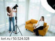 Beautiful asian woman Vlogger and blogger recording video for social media content live streaming at home. Стоковое фото, агентство Ingram Publishing / Фотобанк Лори