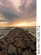 View south of Furadouro beach in Ovar on a stormy day at sunset. Стоковое фото, агентство Ingram Publishing / Фотобанк Лори