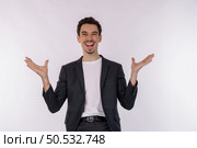 Portrait of puzzled clueless young businessman arms out asking why what’s the problem who cares so what, I don’t know on isolated background. Стоковое фото, агентство Ingram Publishing / Фотобанк Лори