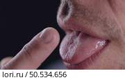 Man Licking Finger Demonstrating Bacterial Transmission Risk. Стоковое видео, видеограф Илья Шаматура / Фотобанк Лори