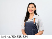 Portrait Asian young woman in waitress uniform smile with happy, Free space to insert product for advertising, isolated on white background. Стоковое фото, агентство Ingram Publishing / Фотобанк Лори