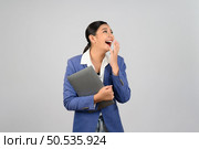 Portrait Asian young woman in officer uniform feel exciting during holding laptop computer in hand posture,  Pretty girl smiling with happy, isolated on white background. Стоковое фото, агентство Ingram Publishing / Фотобанк Лори