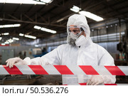 Restricted area, officials employ white and red stripes to block the area where a chemical leak is occurring. To prevent individuals from coming into contact with potentially dangerous chemicals, Стоковое фото, агентство Ingram Publishing / Фотобанк Лори