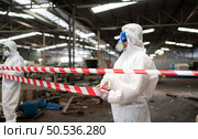Restricted area, officials employ white and red stripes to block the area where a chemical leak is occurring. To prevent individuals from coming into contact with potentially dangerous chemicals, Стоковое фото, агентство Ingram Publishing / Фотобанк Лори