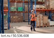 Portrait of warehouse supervisor in a large warehouse with their own preparation for the day’s work. Стоковое фото, агентство Ingram Publishing / Фотобанк Лори